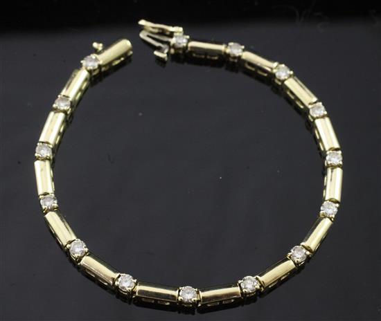 A modern 14ct gold and diamond line bracelet, 7.25in.